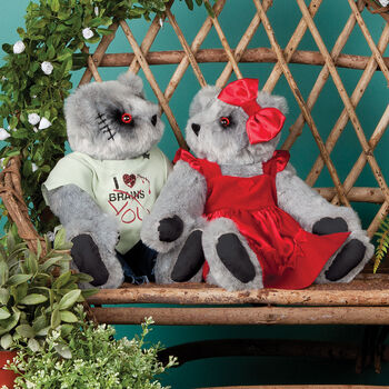 15" Zombie Love and Zombie Sweetheart Bear - Seated on a bench in a garden jointed bears with blackened eyes, embroidered scars and red heart tattoo on right arms wearing torn t-shirt and jeans and red velvet dress and hairbow - gray fur