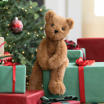 15" Buddy Bear - Front view of Slim seated honey brown bear on a stack of Christmas gifts