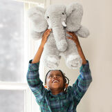 18" Oh So Soft Elephant - Front view of seated gray Elephant with boy in front of a window image number 1