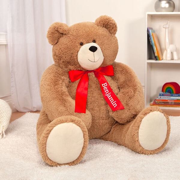 4' Big Hunka Love Bear - Seated golden brown bear with red satin bow with tails, left tail is personalized in white lettering with "Benjamin"