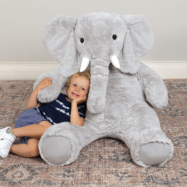 4' Cuddle Elephant - Front view of seated grey plush elephant with child