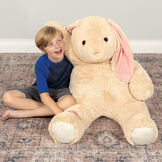 4' Cuddle Bunny- Seated tan bunny in a bedroom scene with child model image number 2