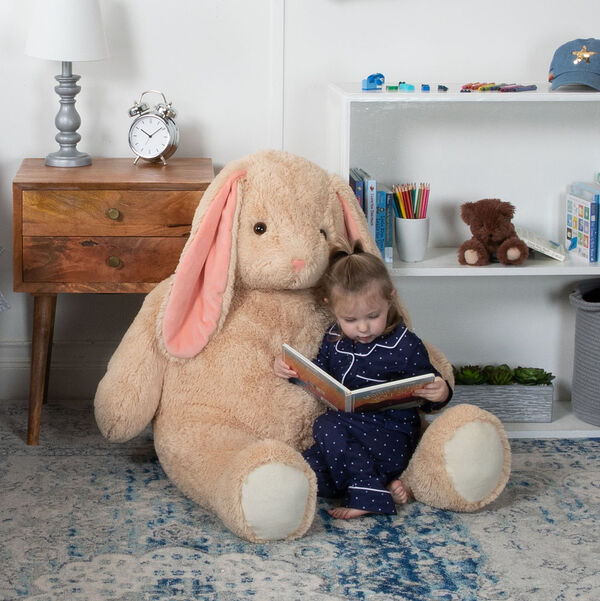 4' Cuddle Bunny- Seated tan bunny in a bedroom scene with child model image number 0