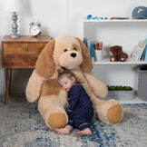 4' Cuddle Puppy - Front view of seated tan plush puppy with child in bedroom scene image number 0