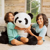 3 1/2' Gentle Giant Panda - Front view of seated black and white Panda with models in living room scene image number 4