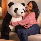 3 1/2' Gentle Giant Panda - Front view of seated black and white Panda with model in a Valentine's Day scene image number 0