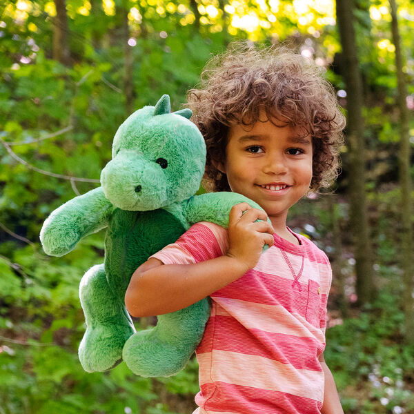 15" Cuddle Chunk Dinosaur - Green dinosaur in an outdoor scene with a child