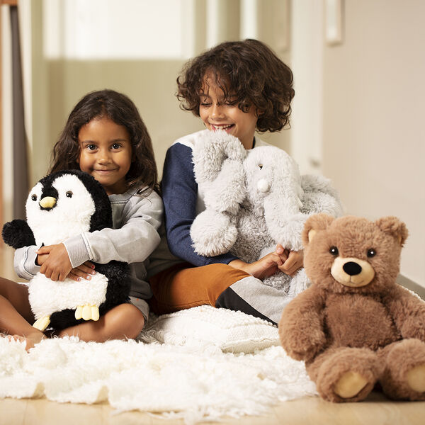 18" Oh So Soft Teddy Bear - Front view of honey brown teddy bear with penguin and elephant and children