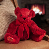 20" Special Edition 40th Anniversary Bear - Seated jointed ruby red bear with red pads and gold Vermont Teddy Bear logo on right foot with red bow in a living room setting image number 2