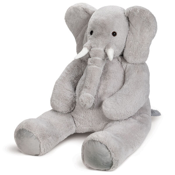 6' Giant Cuddle Elephant - 3/4 view of seated grey plush elephant with white fabric tusks, floppy ears and long trunk