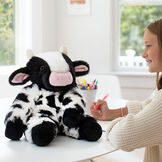 18" Oh So Soft Cow - Black and white Holstein cow with pink nose and ears and a model in a living room scene image number 4