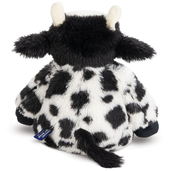 18" Oh So Soft Cow - Back view of seated black and white Holstein cow with tail
