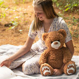 20" Bubba the Fuzzy Teddy Bear - Front view of seated almond brown bear with model in an outdoor scene image number 5