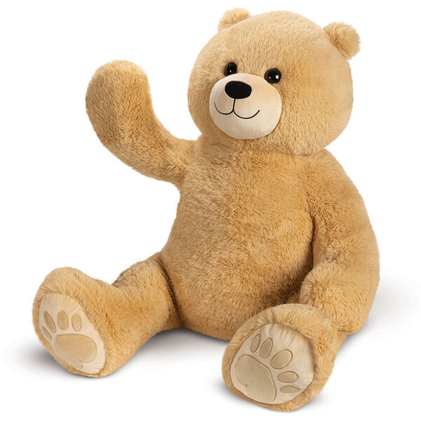 4' Boo The Loveable Big Teddy Bear - Three quarter view of waving seated light butterscotch brown bear with ivory muzzle, smile and hear foot pads