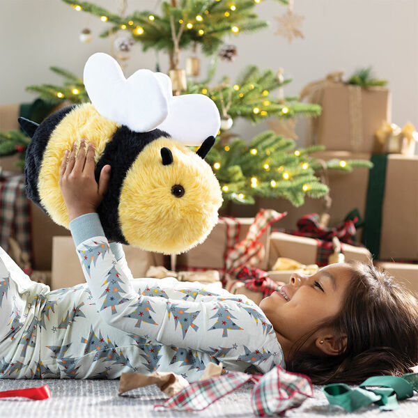 18" Oh So Soft Bee - 3/4 view of stuffed bee with model and Christmas gifts