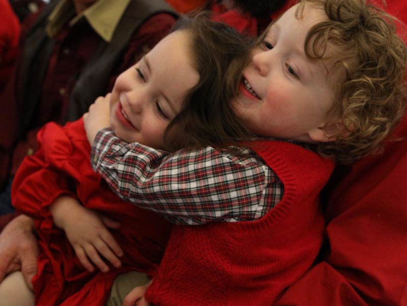 An image of the Cox twins with a teddy bear