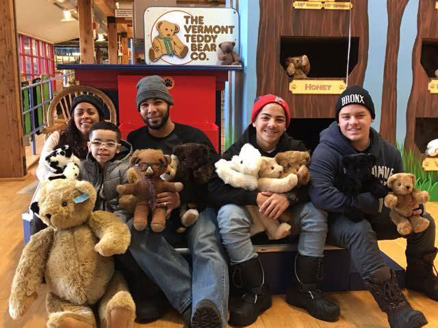 A group of people sitting with teddy bears