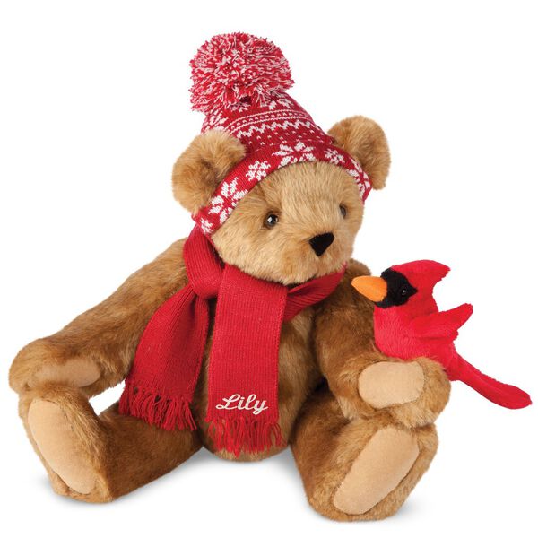 15" Season's Greetings Bear - Front view of seated jointed bear dressed in a knit red and white nordic patterned hat with red scarf and holding a red cardinal. Bottom edge of scarf is personalized with "Lily" in white lettering - Honey brown fur image number 0