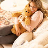 20" World's Softest Bear - Golden brown bear with ivory bow in living room scene with model image number 7