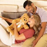 20" World's Softest Bear - Front view of bear with models in a living room scene image number 6